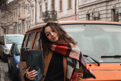 Woman in traditional clothing in city cars 