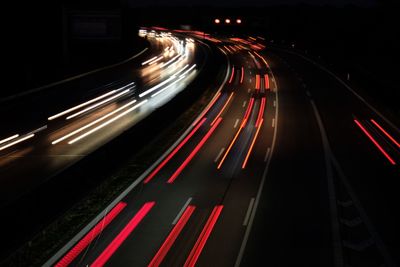 High angle view of light trails on road at night