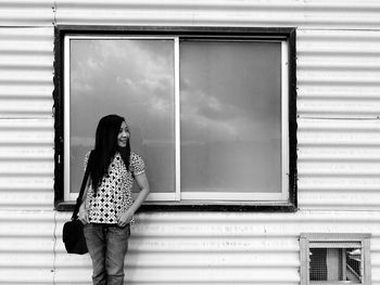 Woman standing against window