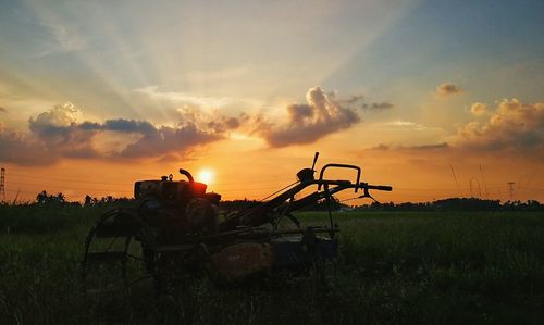 Scenic view of field against sky during sunset