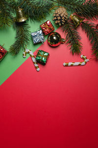Directly above shot of christmas decorations on red background