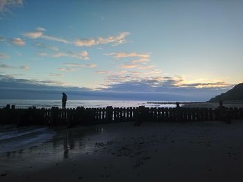 View of beach against cloudy sky