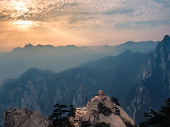 Scenic view of mountains against cloudy sky