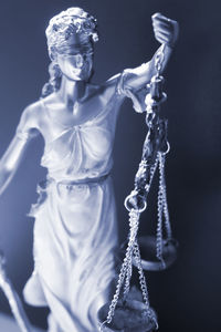 Close-up of lady justice against wall