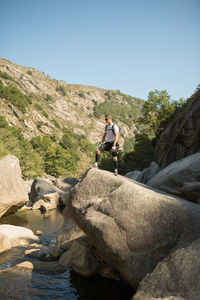 Full length of man on rock against sky