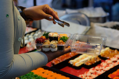Midsection of man preparing food