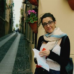 Portrait of smiling young woman standing outdoors