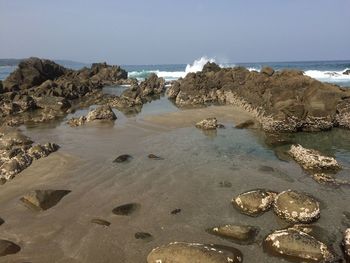 Scenic view of beach against clear sky