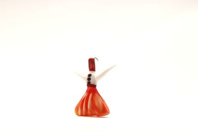 Close-up of red toy over white background