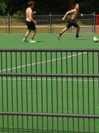 Full length of man playing soccer on field