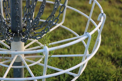 Close-up of metal fence on field