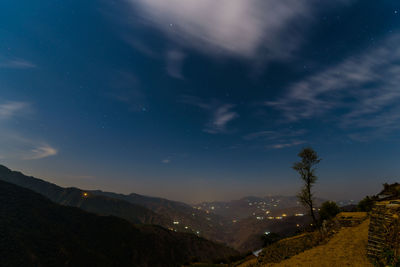 Scenic view of mountains against sky at night