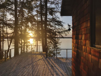 Sunset view from a cabin deck overlooking a lake