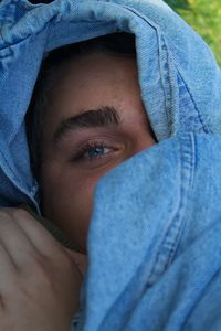 Close-up portrait of young man wearing denim jacket