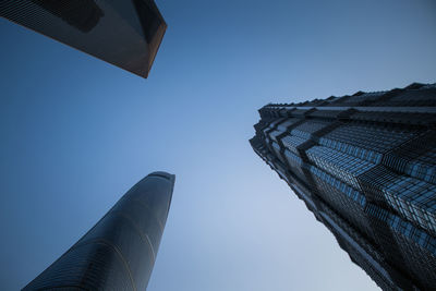 Low angle view of buildings against clear blue sky