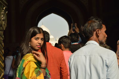 Rear view of men looking at camera