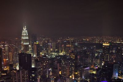 Aerial view of illuminated buildings in city at night