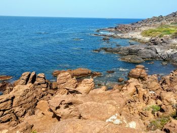 Rocks on beach against sky