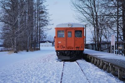 Train on snow covered railroad tracks during winter