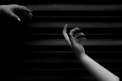 Close-up of hand holding piano