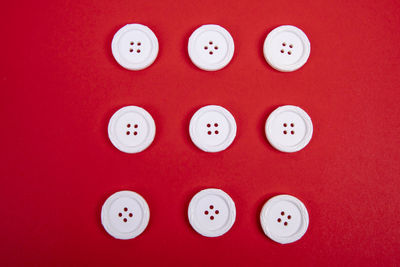 Directly above shot of red buttons on table