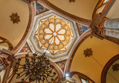Low angle view of ornate ceiling in temple building