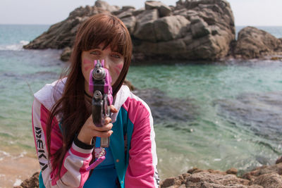 Portrait of woman drinking water from beach