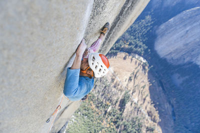 Rock climber crack climbing on the nose, el capitan in yosemite