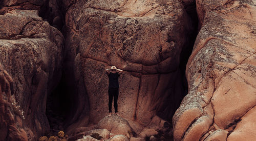 Rear view of man standing on rock