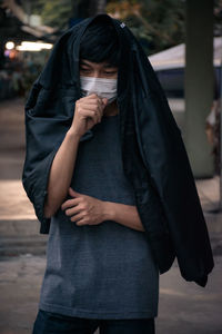 Midsection of woman standing on street