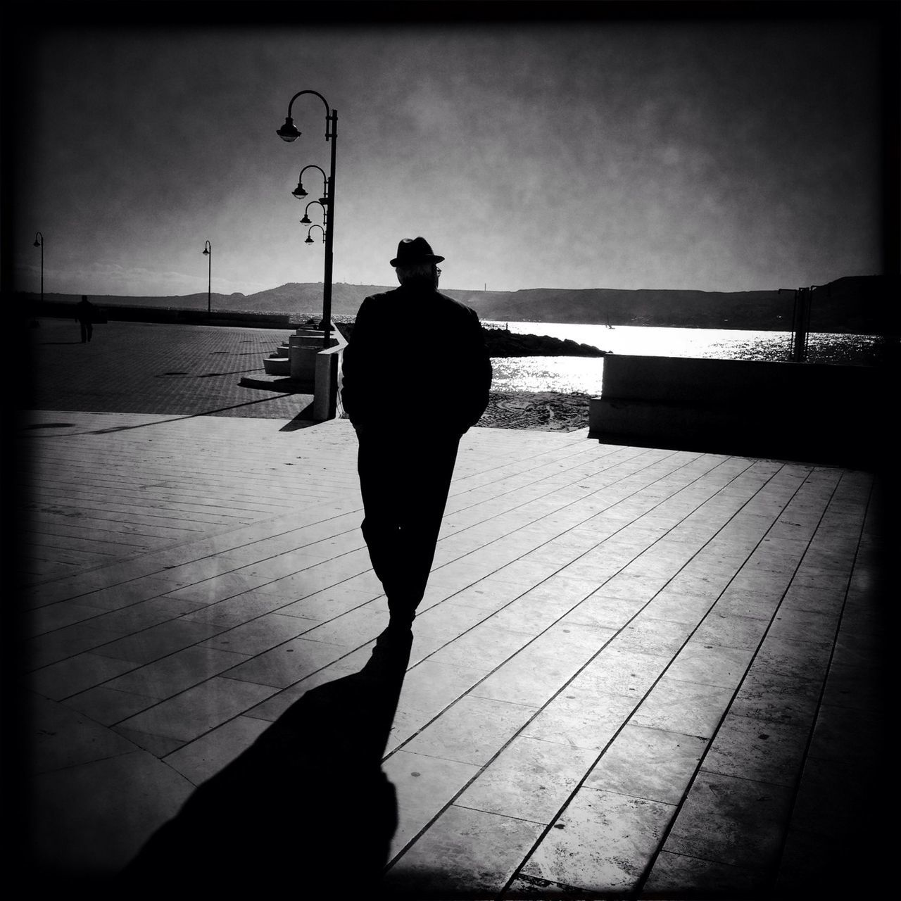 rear view, full length, lifestyles, walking, standing, transfer print, leisure activity, men, sky, person, railing, auto post production filter, shadow, silhouette, boardwalk, casual clothing, pier