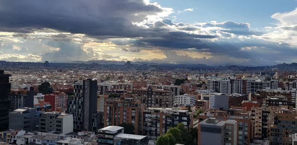 High angle view of buildings in city against sky