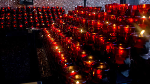 Close-up of illuminated candles in temple