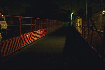 View of empty footpath at night