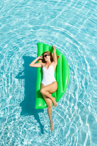 High angle view of man sitting in swimming pool