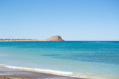 Scenic view of sea against clear blue sky