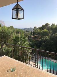 View of swimming pool by balcony against sky