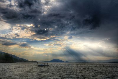 Scenic view of sea against cloudy sky