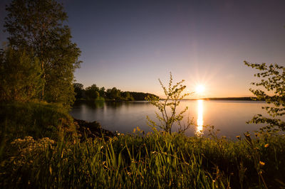 Scenic view of lake against sky during sunset