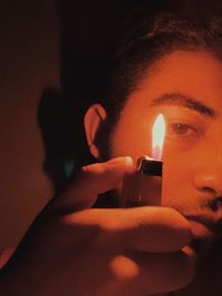 Portrait of man holding cigarette lighter