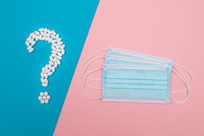 High angle view of pink umbrella on table against blue background