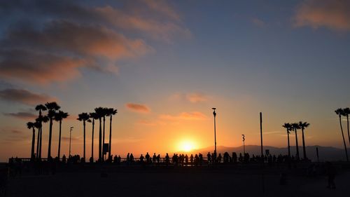 Silhouette people against sky during sunset