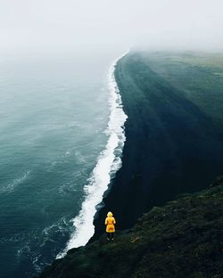 Woman standing on hazy beach