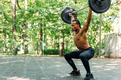 Full length of man exercising on footpath