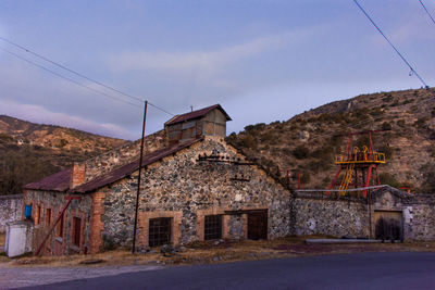 View of historic building by road against sky