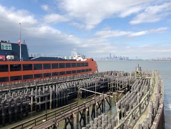 Ship in city against sky