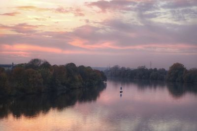 Scenic view of lake against sky during sunset