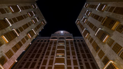 Low angle view of modern buildings at night