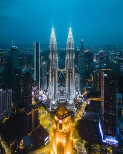 High angle view of illuminated buildings in city at night