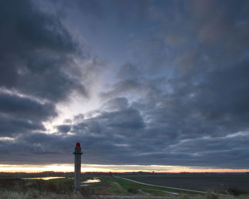 Rear view of person standing against sky during sunset